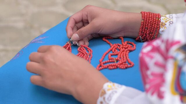 Cinematic slow motion clip of a young girl resting her beeds on the traditional oufit of Cayambe&ntilde;as in Equador.