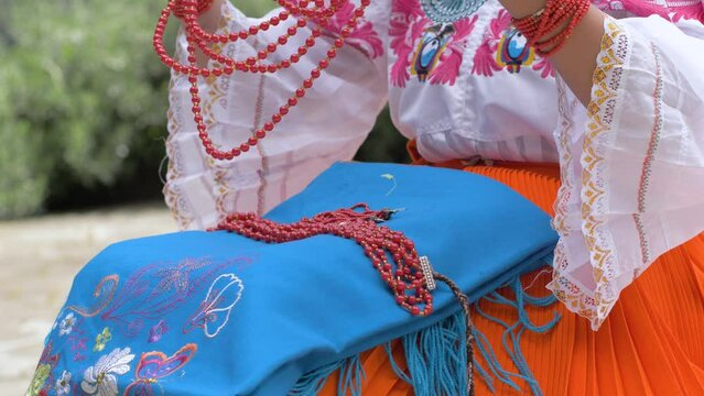 Cinematic slow motion clip of a young girl resting her beeds on the traditional oufit of Cayambe&ntilde;as in Ecuador.