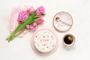 Obraz na płótnie Canvas Sweet bento cake with cup of coffee and beautiful flowers on white background. International Women's Day