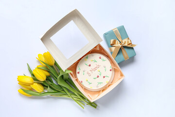 Sweet bento cake with gift box and beautiful yellow tulips on white background. International Women's Day