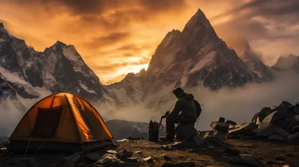 Tuinposter Mountain climbers travelers pitch a tent, camping equipment at the top of the Mountain at sunset. Adventure, Lifestyle, Outdoor Travel, Summer Vacations, Landscape Concepts. © liliyabatyrova