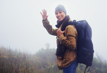 Happy woman, hiking and portrait in nature with wave and greeting for morning adventure in...