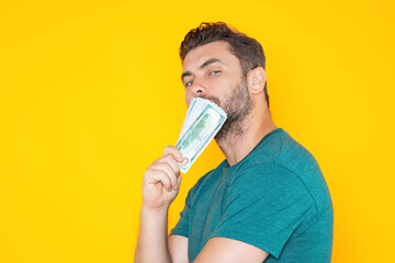 Man hold money on yellow studio isolated background. Portrait of rich man with money dollar bills....