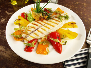 Grilled Fish Fillet with roasted Peppers and Vegetables - Low Carb Sea Food Plate on wooden Background - 748543189
