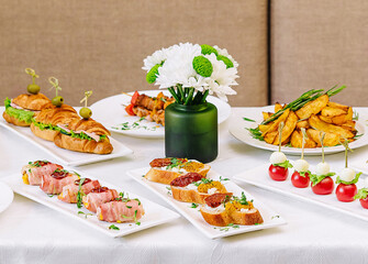 table with different gourmet snacks front view
