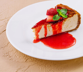 cheesecake with strawberry jam on plate
