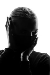 anonymous female silhouette in high contrast light