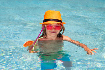 Boy kid in pool drinking cocktail. Happy lifestyle kids. Water toy, healthy outdoor activity for children. Kids beach fun.