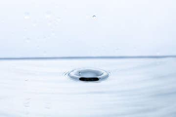 A dynamic splash forming an indentation on the water's surface. Ideal for illustrating the energy...