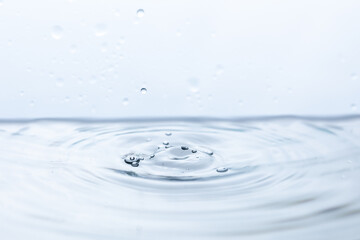 Captivating image of a water droplet reflecting off pristine water, creating a mesmerizing splash....