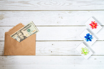 20 dollars in the envelope with giftbox on a wooden table. Topview background with copyspace	