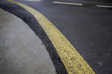 Yellow line on the asphalt - 748563173