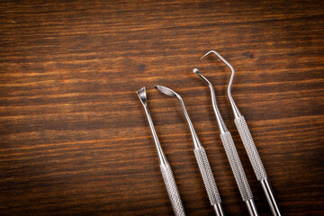 Dentist and dental hygienist tools on a dark wooden background