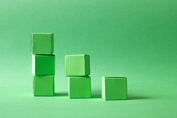 Ascending Stack of Green Cubes on a Soft Teal Background - Geometric Art