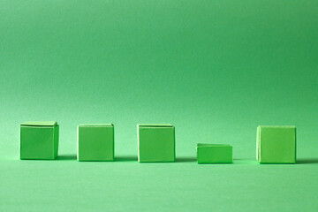 Arranged Green Cubes Casting Shadows on Green Teal Surface - Abstract Design Representing Eco-Friendly Development
