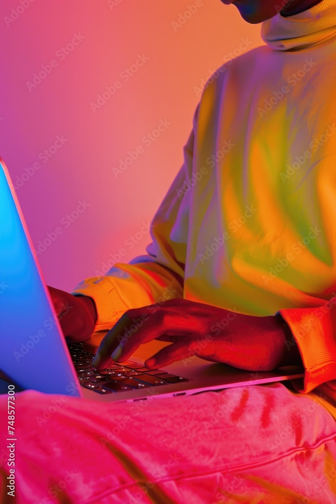 Aufkleber A man sitting on a bed and using a laptop computer. Suitable for technology and work from home concepts