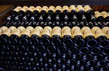 Fototapeta premium Neatly arranged bottles of Chianti Classico wine in a wine shop in Monteriggioni near Siena. Italy