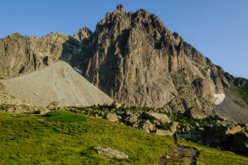 hiker on the road, Midi d'Ossau peak, 2884 meters, Pyrenees National Park, Pyrenees Atlantiques, France
