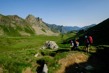 hikers descending into the valley, Col de Souzon, Midi d'Ossau peak, 2884 meters, Pyrenees National Park, Pyrenees Atlantiques, France
