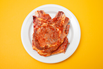 sliced raw pork meat with sauce and pepper in white plate