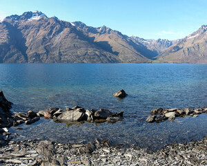 Crystal clear blue water of Lake Wakatipu with Cecil and Walter Peak in the Southern Alps on New Zealand's South Island