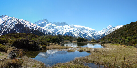Southern Alps and Aoraki Mt Cook reflecting in the pristine Sealy Tarns on a beautiful day on New Zealand's South Island