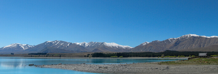 Panoramic view of the Church of the Good Shepherd with Lake Tekapo and Southern Alps mountain range on New Zealand's South Island
