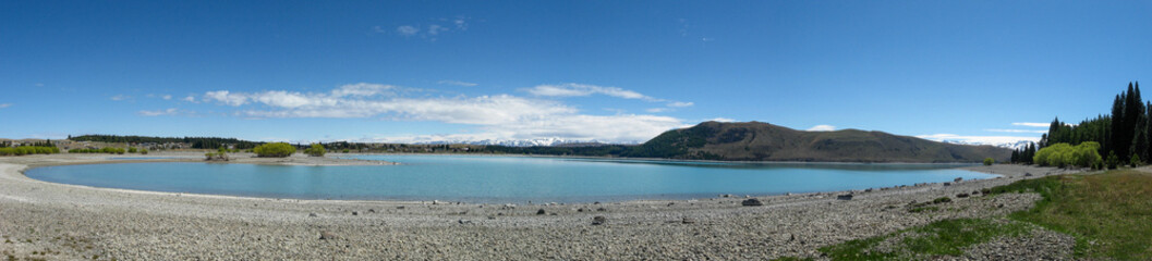 Panoramic view of Lake Tekapo and Southern Alps mountain range on New Zealand's South Island