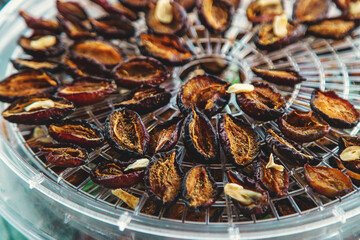 Plums dried in a dehydrator. Selective focus.