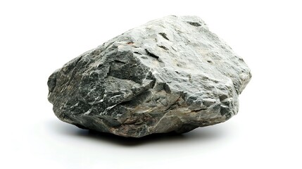 A large, solid rock sits on a white surface. The rock is gray and has a rough texture.