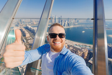 Selfie photo of young crypto businessman smile man tourist on background skyscrapers in Dubai on...