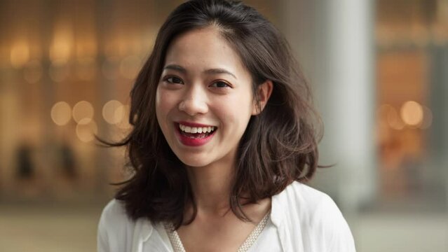 slow motion of happy young woman looking at camera smile talking