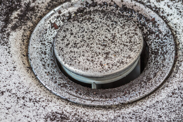 Falling dirty particles from a water filter in a white washbasin. Elements of a filtration system...