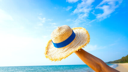 Happy holiday in summer with Sun Hat on the beach as blue sky background