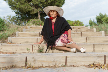 latin grandmother with a hat at  the field