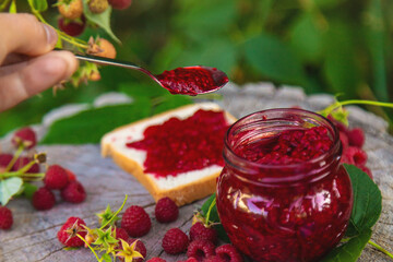 Raspberry jam in the garden. Selective focus.