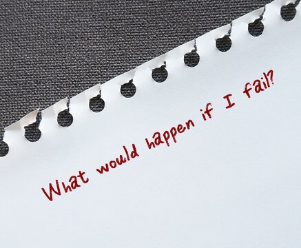 Torn note paper with handwriting What Would Happen If I Fail? - self doubt concept - lack of confidence regarding one own abilities - imposter syndrome with work or relationships