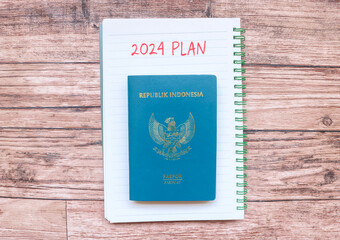 New year's resolutions 2024 on the table. 2024 plan with passport on wood background. 2024 plan writing on wooden table. New Year 2024 Theme
