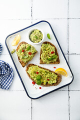 Mashed avocado on toast with lemon and chili pepper