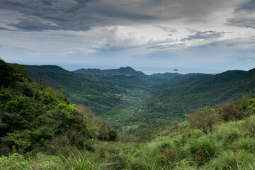 Fototapeta premium Overlook Wanli district from Fengguikou mountain trail, in New Taipei City, Taiwan.