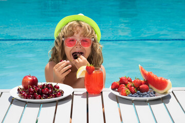 Healthy food. Outdoor leisure activity with kids by swimming pool. Summertime. Summer cocktail and...
