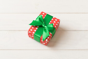 Wrapped christmas or other holiday handmade present in paper with colored ribbon. Present box,...