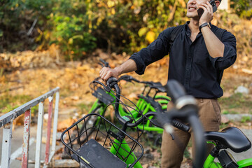 business man holding mobile using bike rental digital phone app scanning qr code to rent electric...