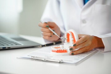 Engaging dental consultation with a female model discussing men's dental appointments at a professional desk meeting, emphasizing oral health and dental care for men.