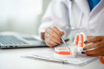 Engaging dental consultation with a female model discussing men's dental appointments at a professional desk meeting, emphasizing oral health and dental care for men.