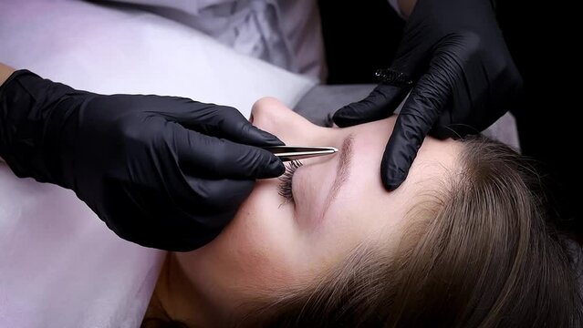 Plucking eyebrows and preparing them for the permanent makeup procedure. Permanent makeup procedure, performing PMU of eyebrows