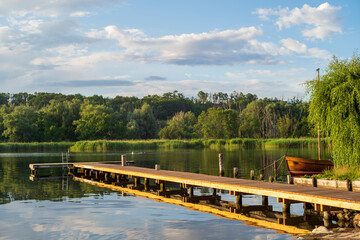 wooden jetty in a lake with a boat