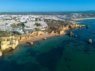 Praia de dona Ana, Ponta da Piedade, aerial view of famous rock formations with arches at sunset, Lagos, Algarve, Portugal.