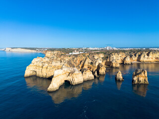 Ponta da Piedade, aerial view of famous rock formations with arches at sunset, Lagos, Algarve, Portugal.