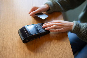 a Person Using Credit Card and enter the password on bank wireless terminal Reader